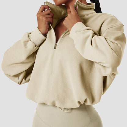 FITNESS MODEL WEARING A BEIGE, CROPPED, PAPER BAG SWEAT SHIRT FROM VIBRAS ACTIVEWEAR.