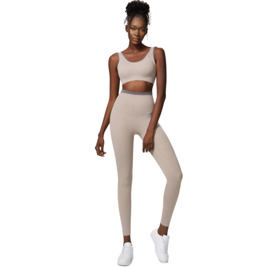 African American model wearing an ivory, high waisted, squat proof matching workout set from Vibras Activewear.