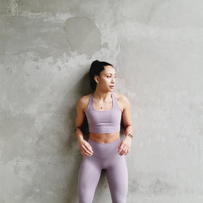 Front view of a fitness model wearing a dusty pink matching workout set from Vibras Activewear.