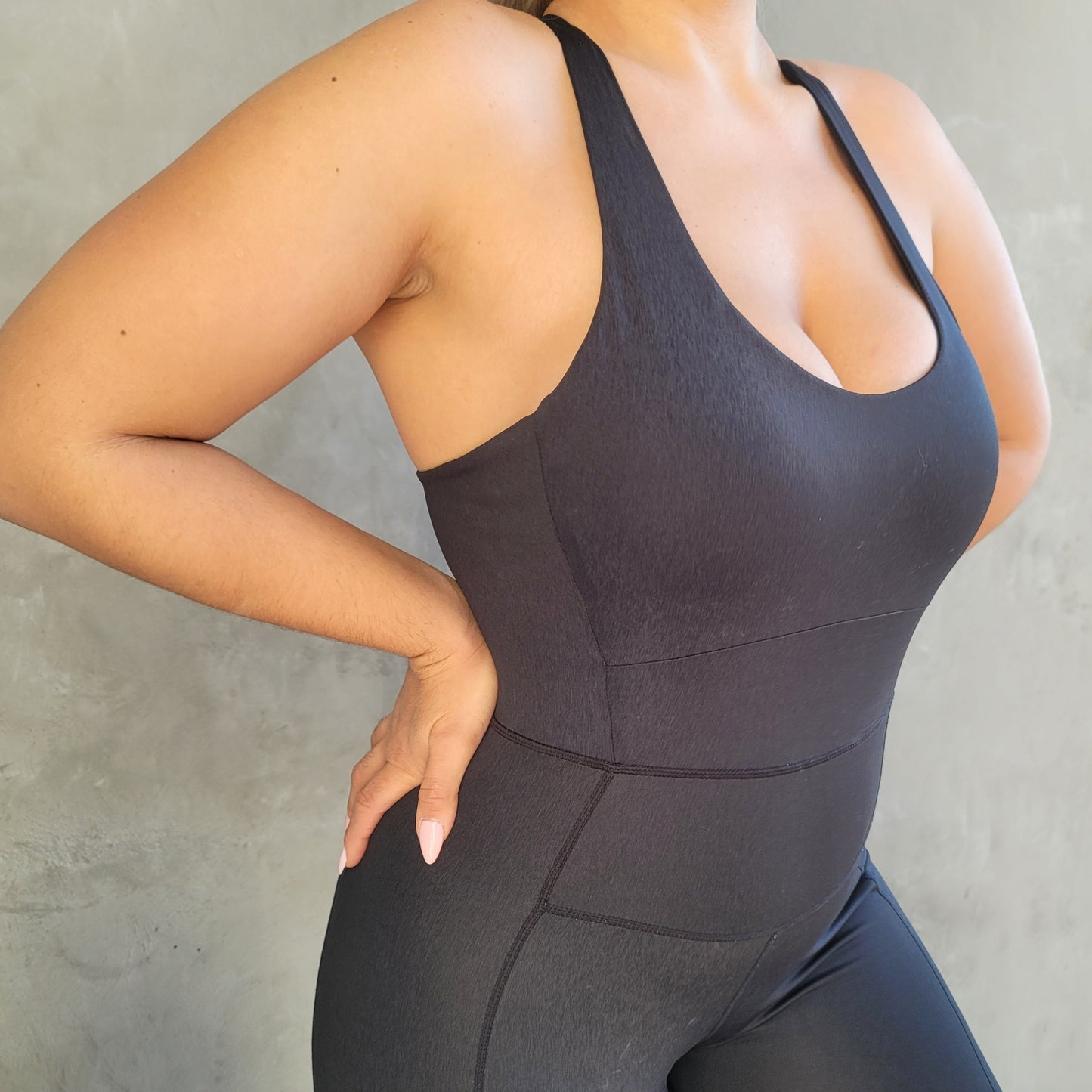 Model wearing the Melina Pilates Jumpsuit in Black.