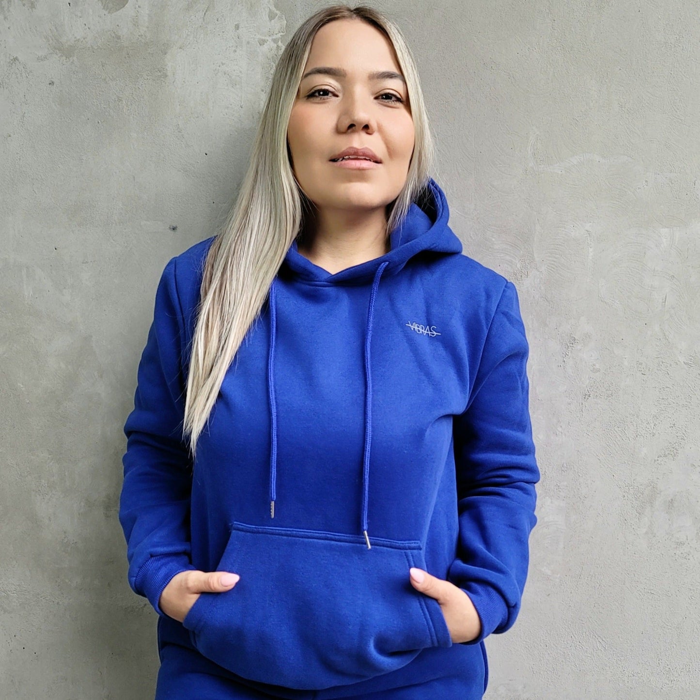 MODEL WEARING A COBALT MATCHING TRACKSUIT  FROM VIBRAS ACTIVE WEAR.