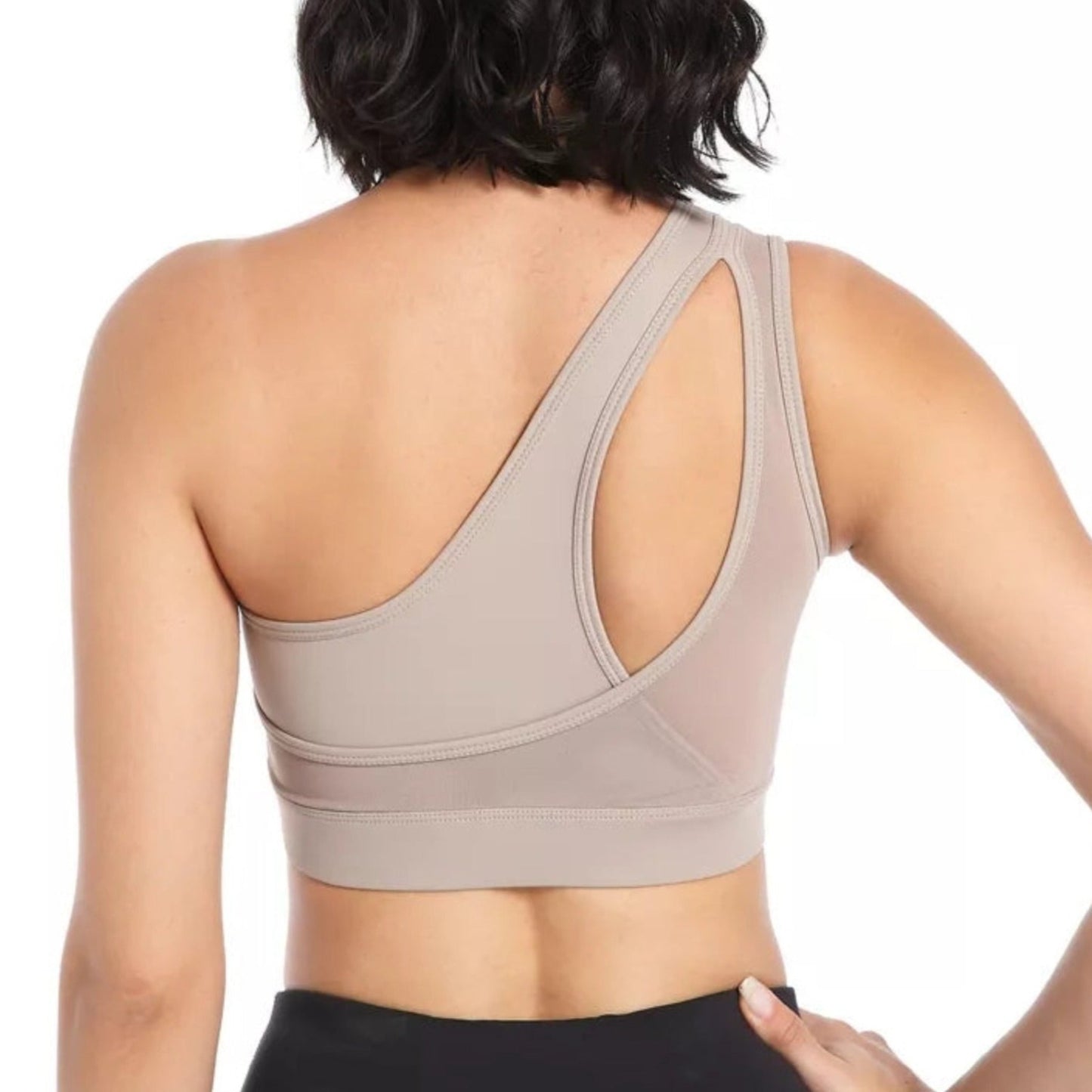 BACK SHOT OF FITNESS MODEL WEARING A ONE SHOULDER,  TAN, HIGH IMPACT SPORTS BRA FROM VIBRAS ACTIVEWEAR.