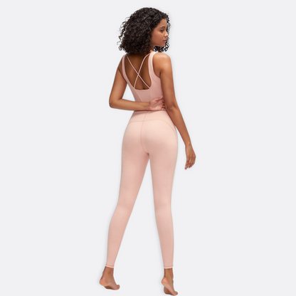 Back view of model posing in a sexy, rose coloured jumpsuit from Vibras Activewear