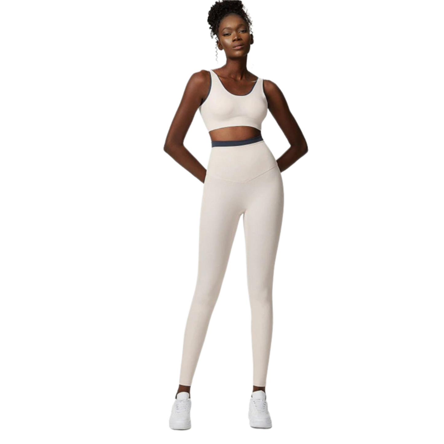 African American model wearing an off white, high waisted, squat proof matching workout set from Vibras Activewear.