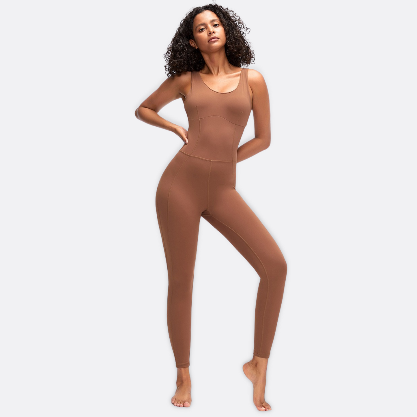 Fitness model in a sexy, brown jumpsuit/ bodsyuit from Vibras Activewear