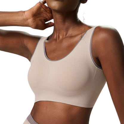 FRONT PHOTO OF FITNESS MODEL WEARING A TAUPE SPORTS BRA FROM VIBRAS ACTIVEWEAR.