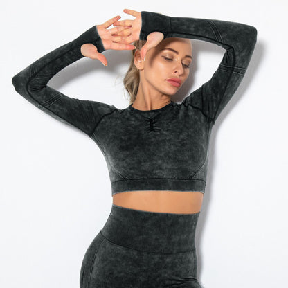 FITNESS MODEL STRETCHING IN  ARIA WORKOUT CROP TOP  IN BLACK  FEATURING THUMBHOLES ON SLEEVES, FROM VIBRAS ACTIVEWEAR.
