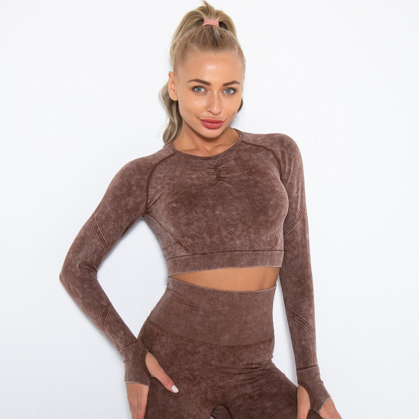 MODEL WEARING ARIA WORKOUT CROP TOP  IN BROWN  FEATURING THUMBHOLES ON SLEEVES, FROM VIBRAS ACTIVEWEAR.