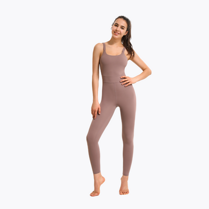 Fitness model posing with a dusty pink comfortable jumpsuit on a white background.