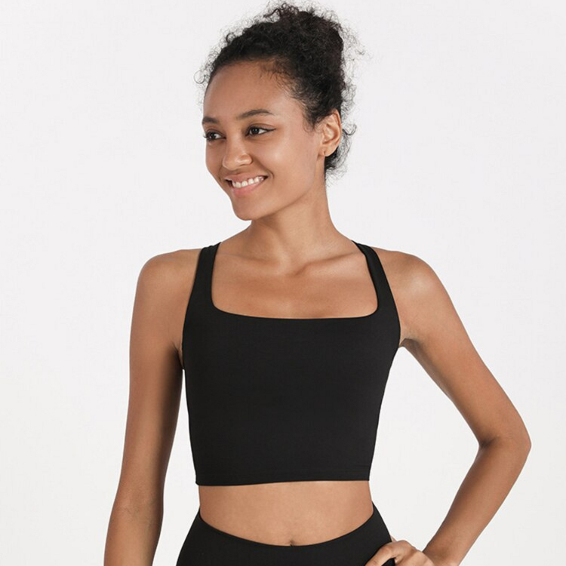 MODEL WEARING A BLACK, SQUARED NECK CROP TOP FROM VIBRAS ACTIVEWEAR