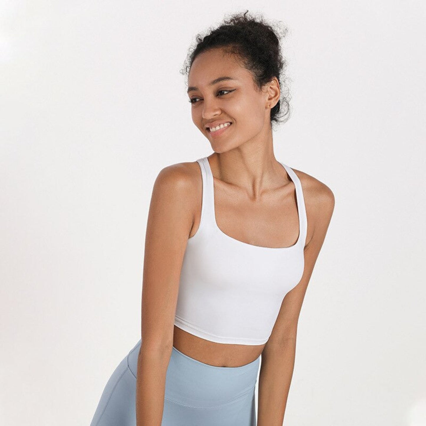 MODEL WEARING WHITE, SQUARED NECK CROP TOP FROM VIBRAS ACTIVEWEAR