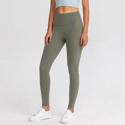 OLIVE COLOURED, HIGH RISE AND SQUAT PROOF LEGGINGS WORN BY MODEL ON A WHITE BACKGROUND