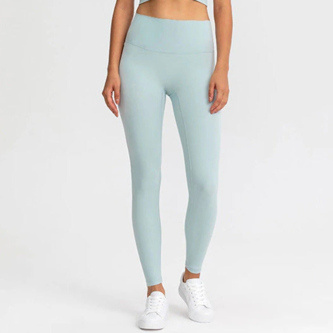 FITNESS MODEL WEARING A MINTY, SQUAT PROOF, AND HIGH WAIST LEGGINGS FROM VIBRAS ACTIVEWEAR.