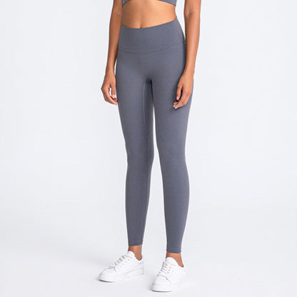 ASH GREY, HIGH RISE AND SQUAT PROOF LEGGINGS WORN BY MODEL ON A WHITE BACKGROUND