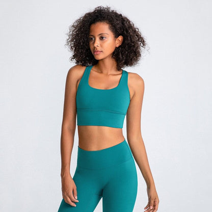 African American woman wearing a beautiful, green and high impact sports bra