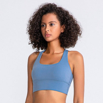 African American woman wearing a beautiful,  light blue and high impact sports bra from vibras activewear.